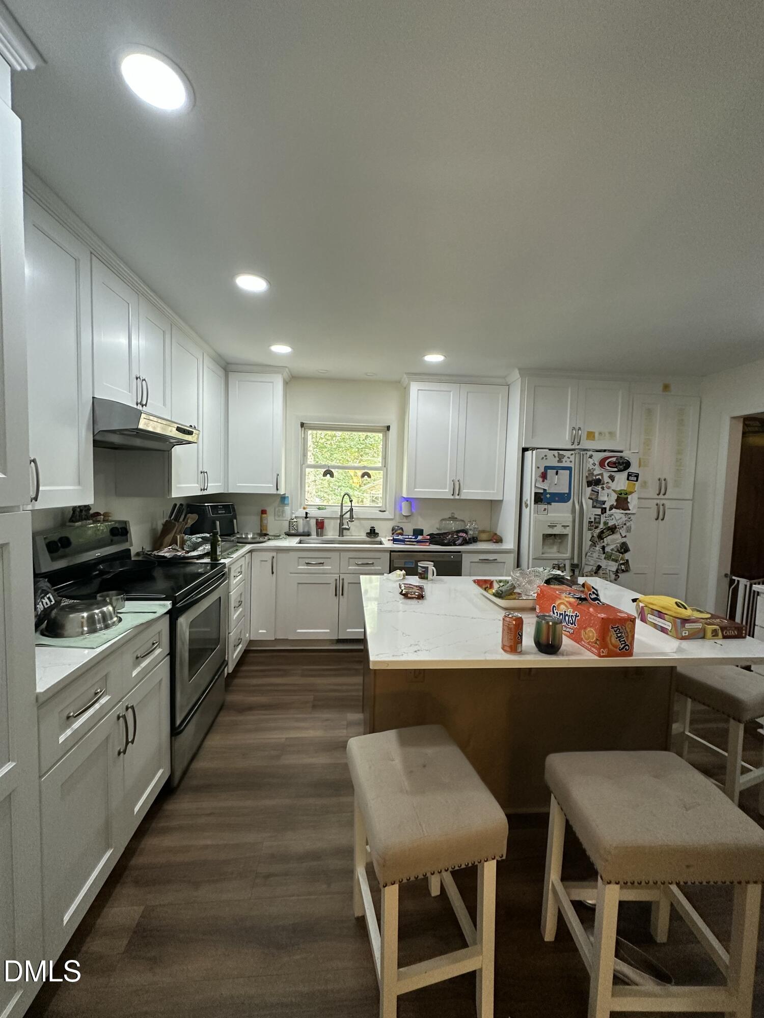 5605 Alpine Drive Raleigh, NC 27609 - Photo 4 of 11 a large kitchen with a table and chairs
