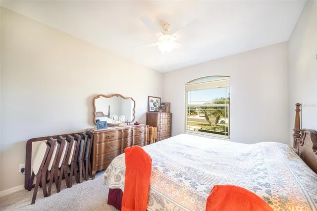 a bedroom with a bed and a dresser with mirror