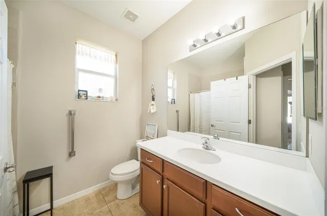 a bathroom with a sink toilet a mirror and shower