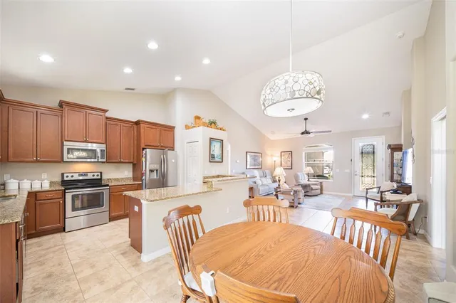 a large kitchen with a table and chairs