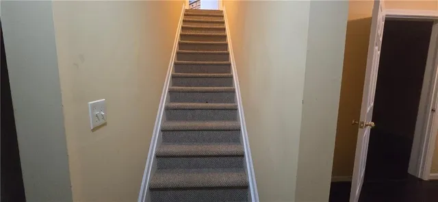 a view of staircase with white walls