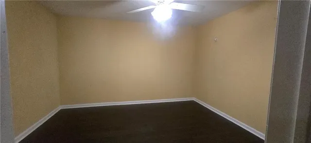 a view of room with window and wooden floor