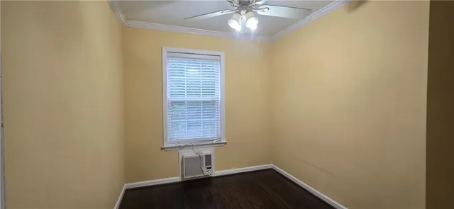 an empty room with a chandelier fan
