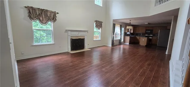 a view of a hallway with wooden floor and a fireplace