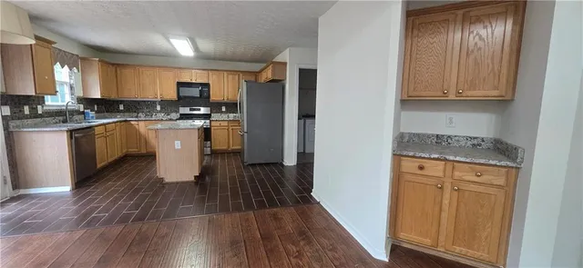 a kitchen with granite countertop white cabinets and white appliances