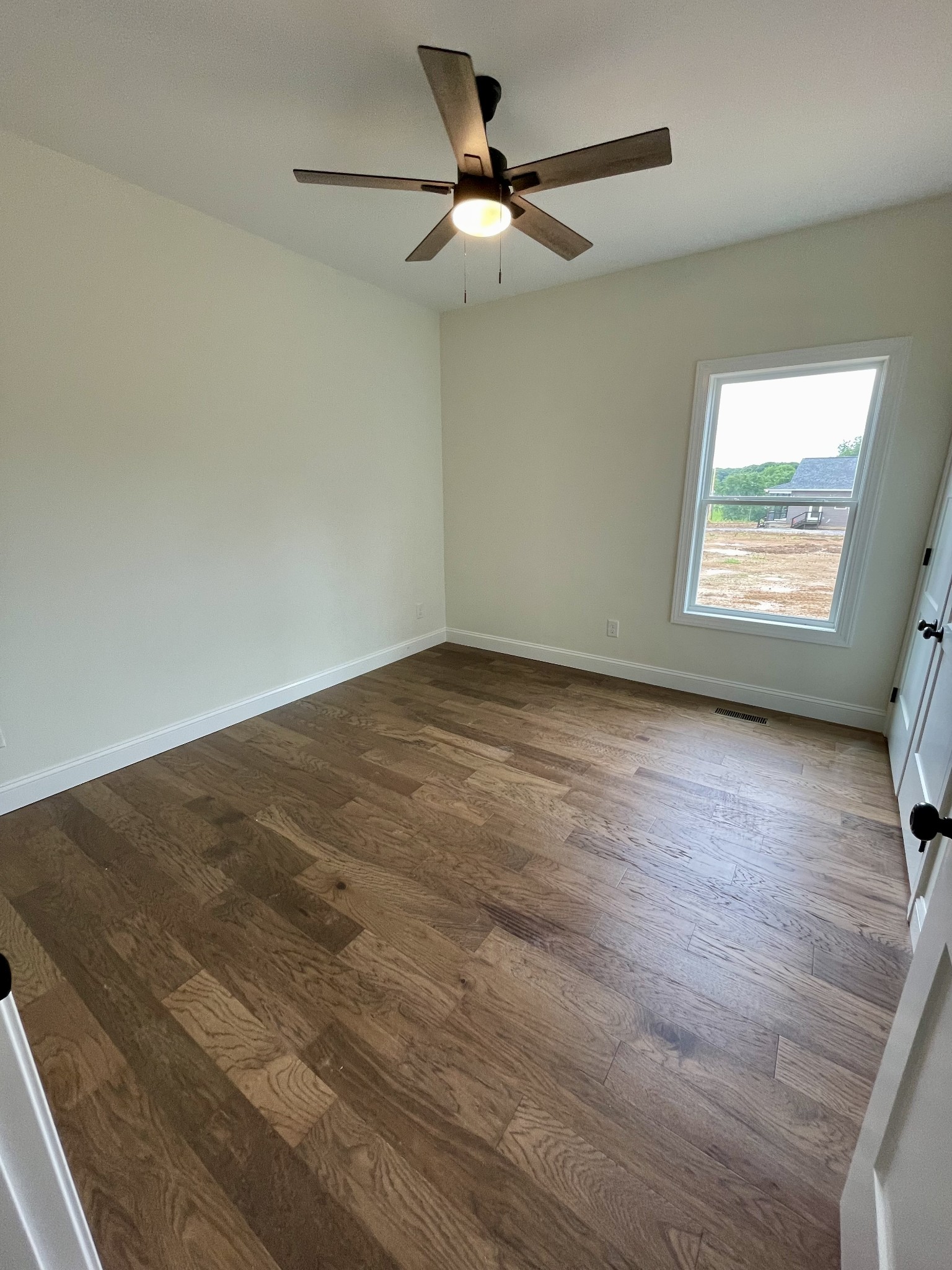58 Union Hill Road Loretto, TN 38469 - Photo 9 of 13 an empty room with wooden floor and windows
