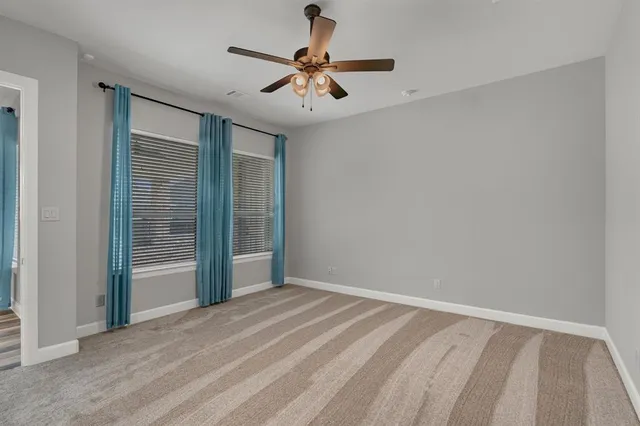 a view of room with window and ceiling fan