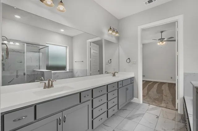a bathroom with a double vanity sink and a mirror