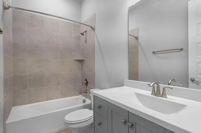 a bathroom with a sink a toilet and a bathtub