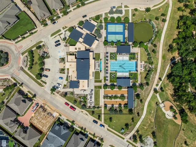 an aerial view of residential houses with outdoor space and river