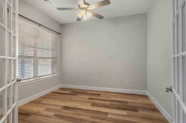 a room with a window and a ceiling fan