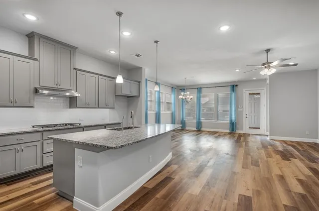 a view of a kitchen with a sink and cabinets