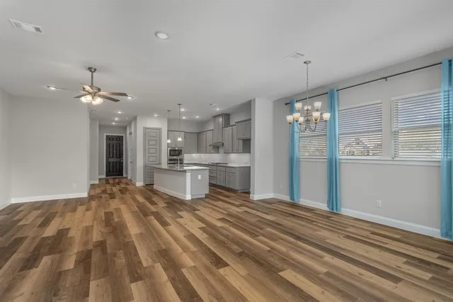 a view of kitchen with sink and refrigerator
