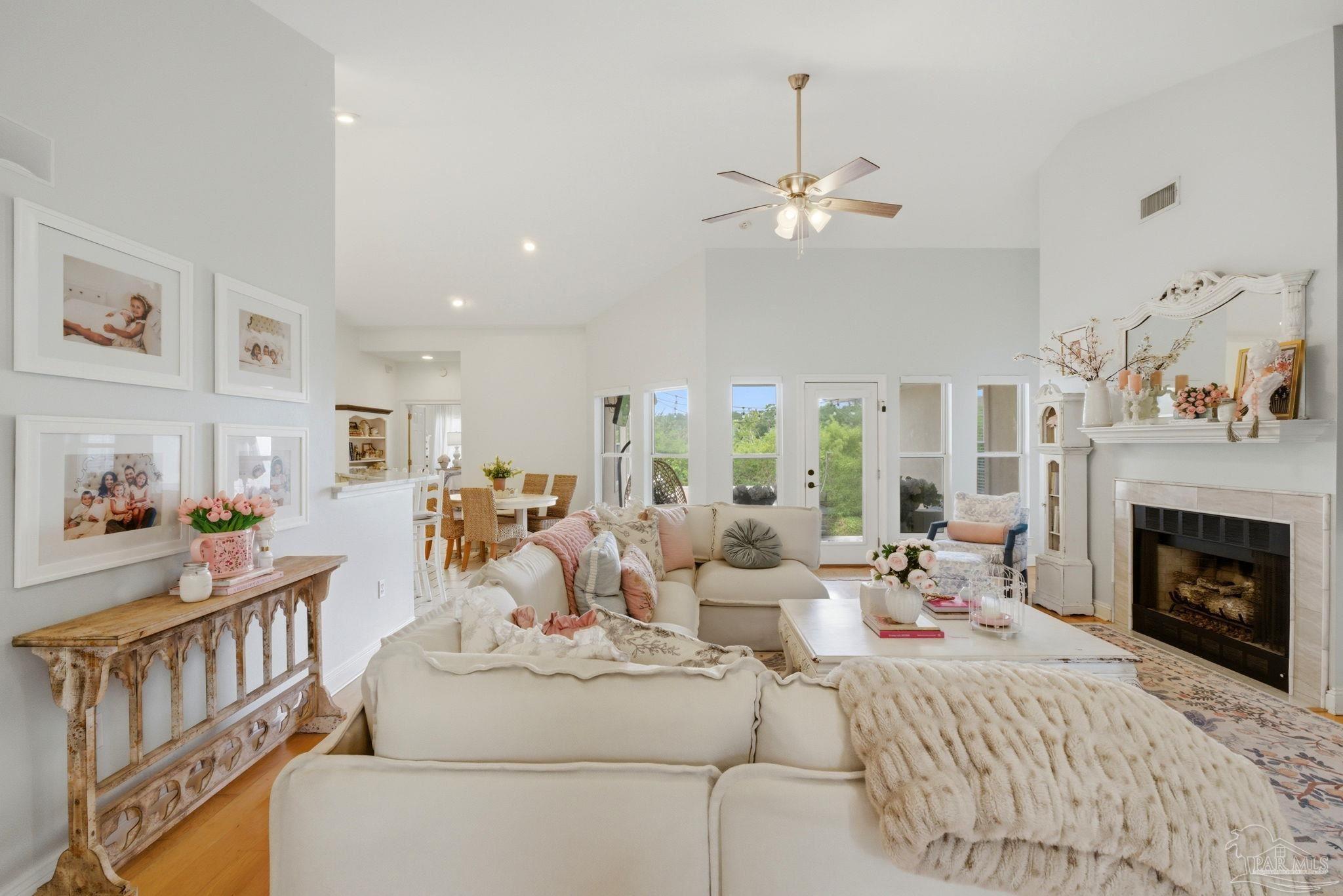 5931 Otter Point Road Pensacola, FL 32504 - Photo 11 of 67 a living room with furniture a fireplace and a chandelier
