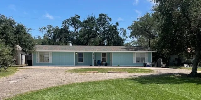 a front view of house with yard and trees