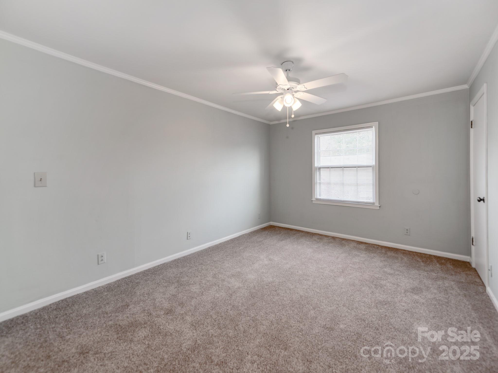 5903 Quail Hollow Road, Unit D Charlotte, NC 28210 - Photo 15 of 23 an empty room with a window and ceiling fan