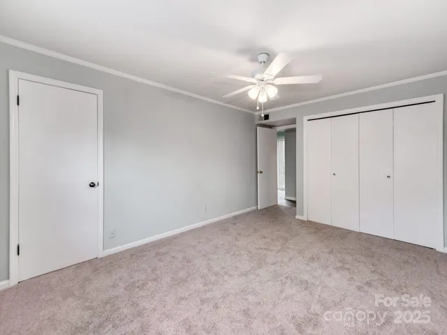 a view of an empty room with a ceiling fan