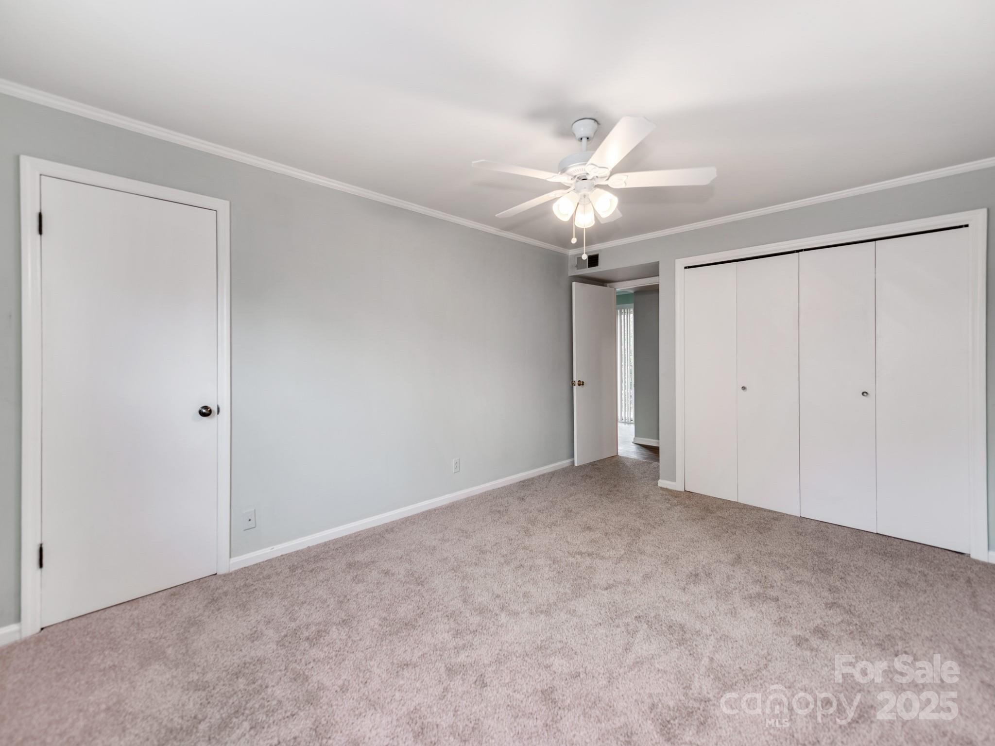 5903 Quail Hollow Road, Unit D Charlotte, NC 28210 - Photo 16 of 23 a view of an empty room with a ceiling fan