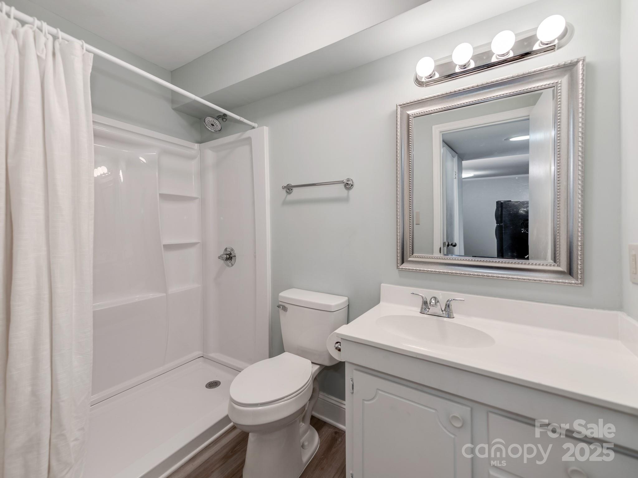 5903 Quail Hollow Road, Unit D Charlotte, NC 28210 - Photo 18 of 23 a bathroom with a sink a toilet and shower