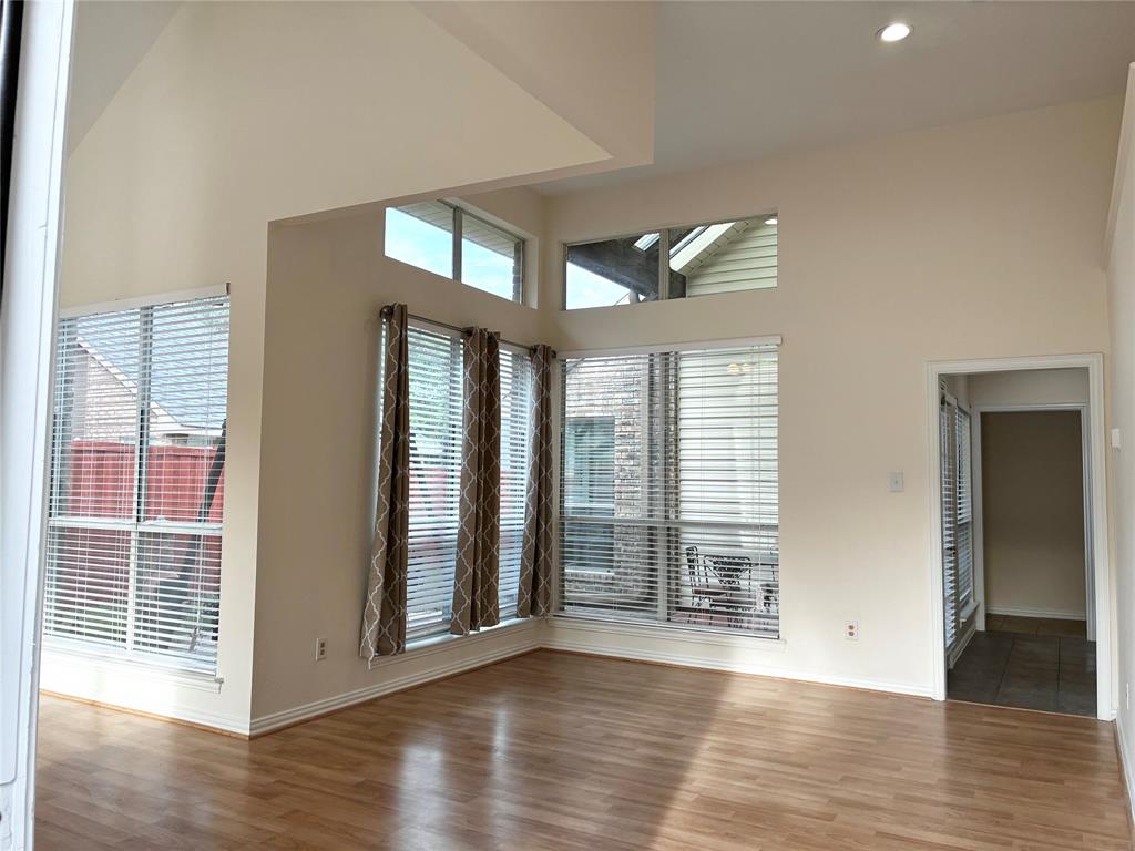7936 Tournament Road Frisco, TX 75035 - Photo 6 of 28 a view of an empty room with wooden floor and a window