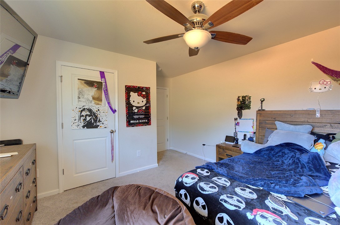 408 Chadwick Lane Walhalla, SC 29691 - Photo 21 of 44 A comfortable bedroom features a wood-bladed ceiling fan and soft carpet underfoot.