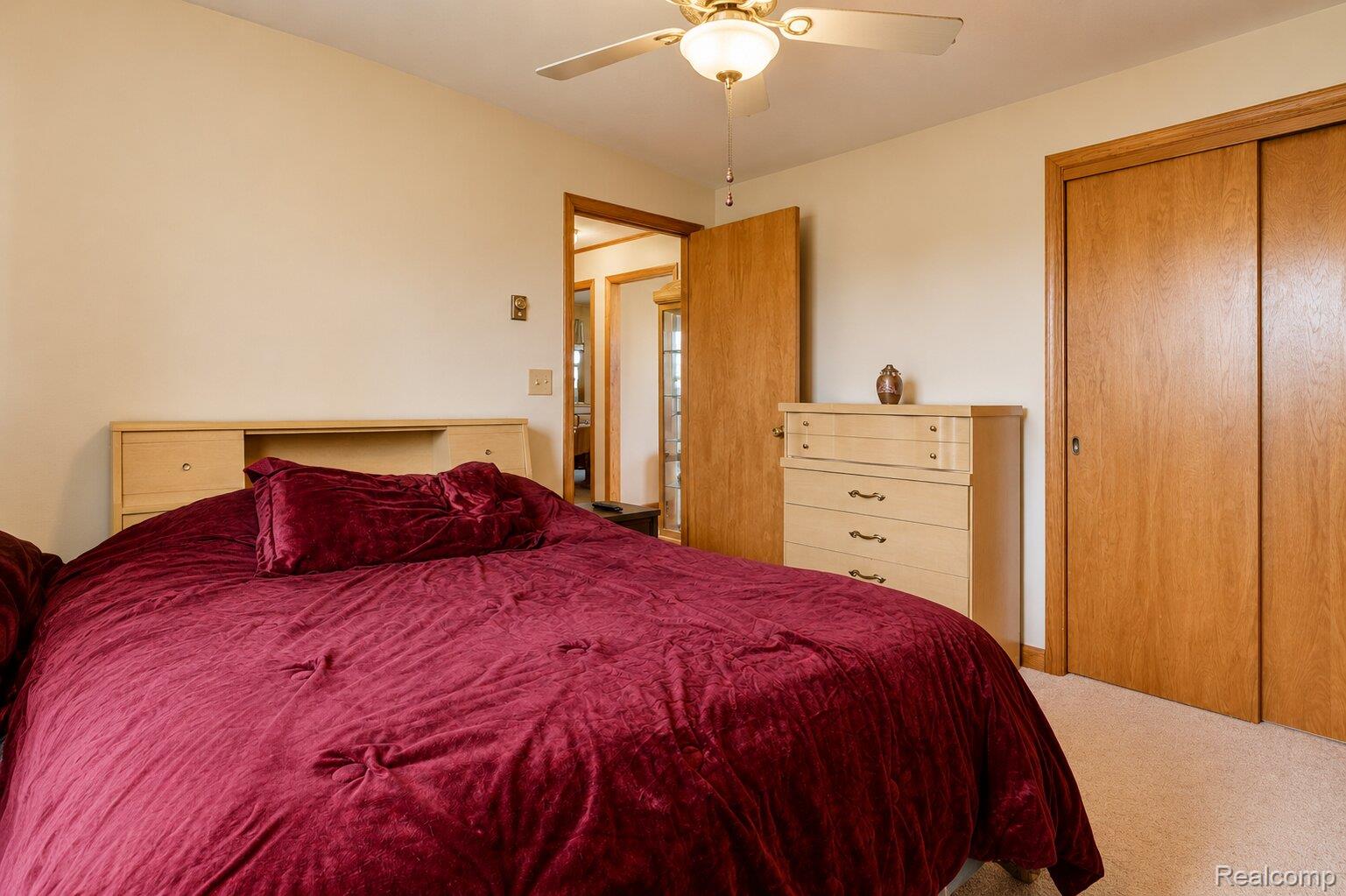 6373 Norman Road Jeddo, MI 48032 - Photo 14 of 32 Bedroom with carpet, a ceiling fan, and a closet