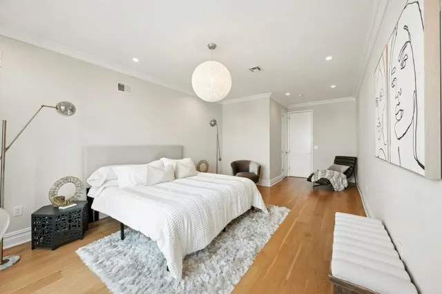 a bedroom with a large bed and a couch