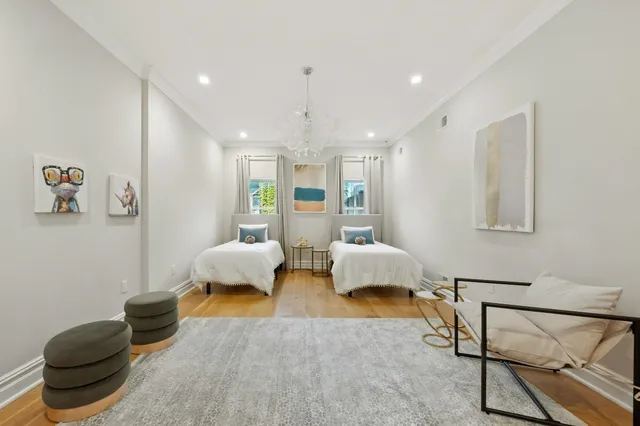 a bedroom with furniture and a wooden floor