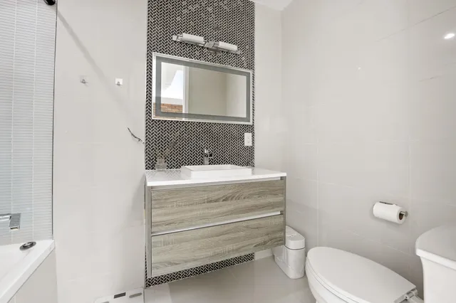 a bathroom with a tub a sink and a shower