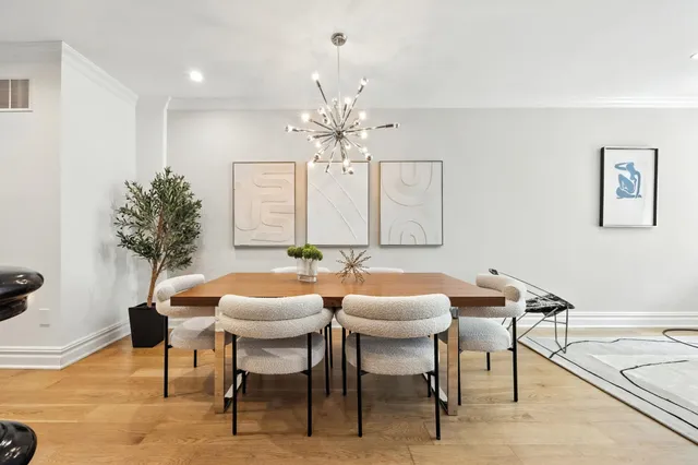 a view of a dining room with furniture and chandelier