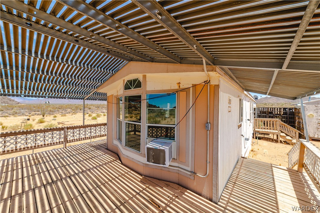 16435 South Wyatt Earp Road Yucca, AZ 86438 - Photo 19 of 57 Expansive covered wooden deck featuring a decorative railing