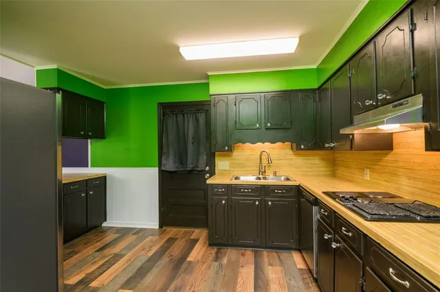 a kitchen with kitchen island a sink stove and cabinets