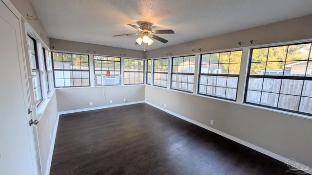 wooden floor in an empty room with a window