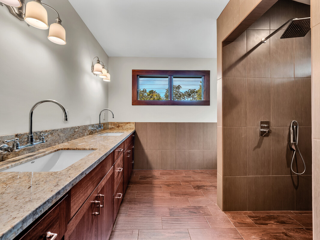 46 Kokea Street Hilo, HI 96720 - Photo 17 of 29 a bathroom with a granite countertop sink a mirror and shower