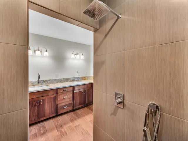 a bathroom with a tub sink and mirror