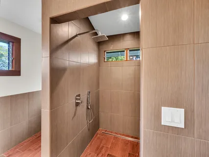 a bathroom with a shower and a glass door
