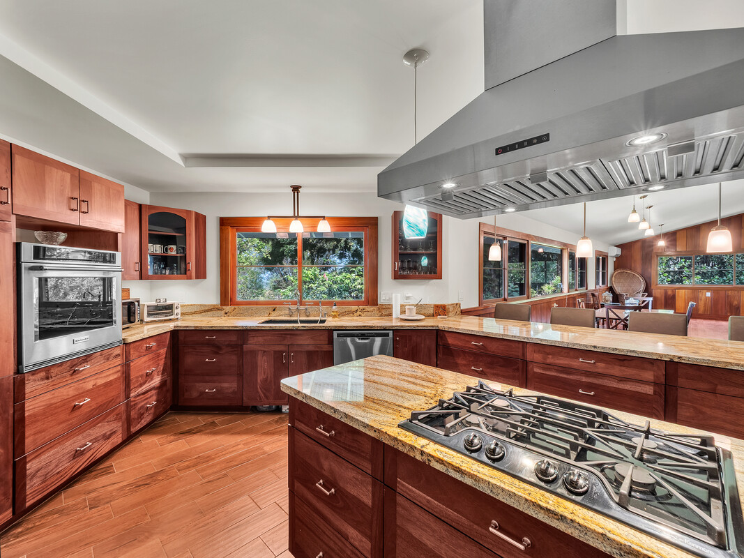 46 Kokea Street Hilo, HI 96720 - Photo 4 of 29 a kitchen with stainless steel appliances granite countertop a stove a sink and a microwave