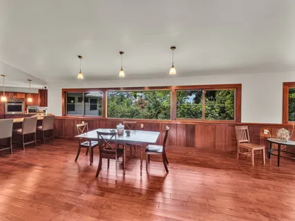 a view of a dining room with furniture window and wooden floor