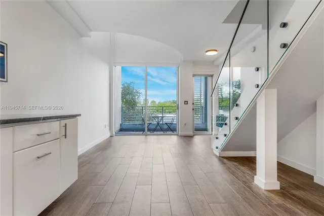 a view of entryway with hardwood floor and front door