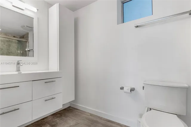 a bathroom with a sink a toilet and vanity