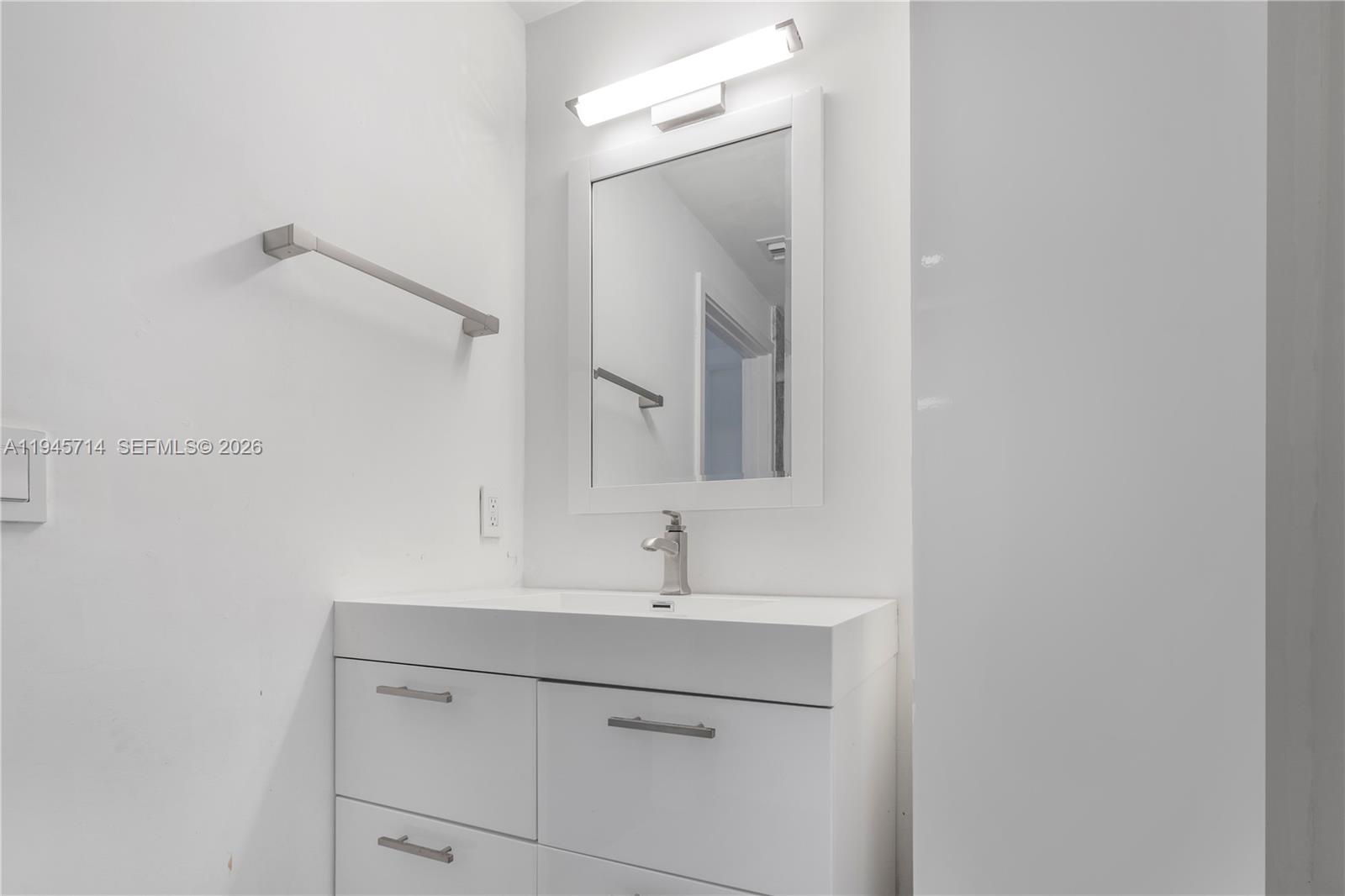 3339 Virginia Street, Unit 339 Miami, FL 33133 - Photo 14 of 24 a bathroom with a sink and a mirror