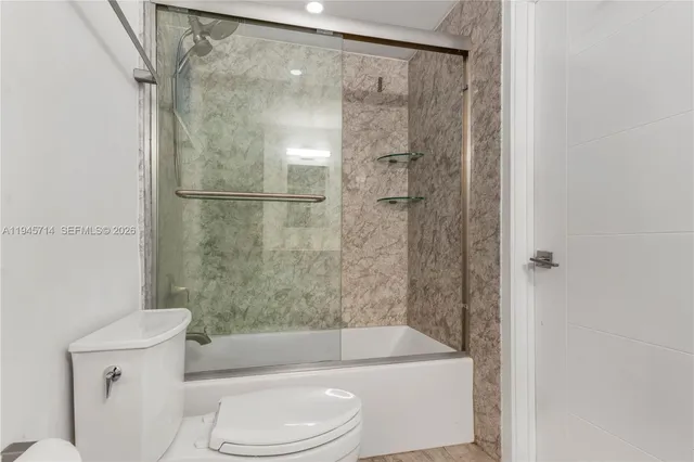a bathroom with a toilet and a bathtub