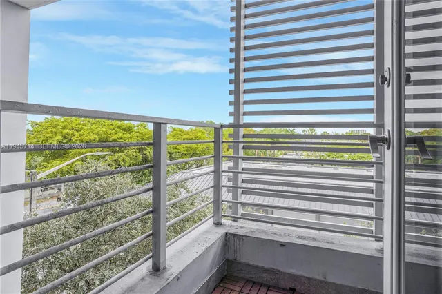 a view of a balcony with two chairs and a table