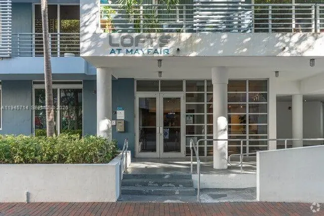 a wooden bench sitting in front of a building