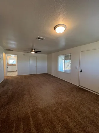 an empty room with a empty space and windows