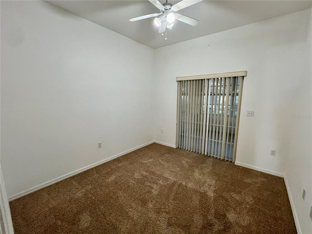 11159 Southwest 71st Terrace Road Ocala, FL 34476 - Photo 14 of 25 an empty room with a fan & a ceiling fan