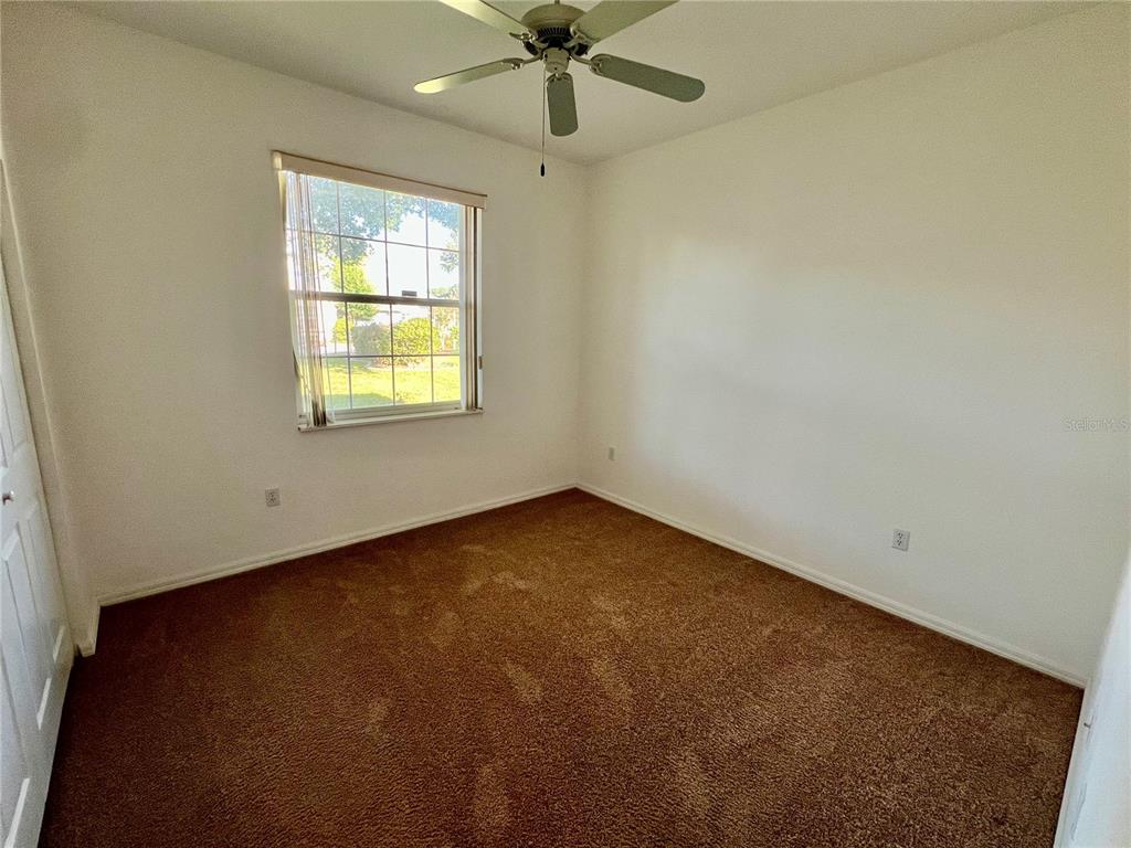 11159 Southwest 71st Terrace Road Ocala, FL 34476 - Photo 23 of 25 an empty room with a window and a fan
