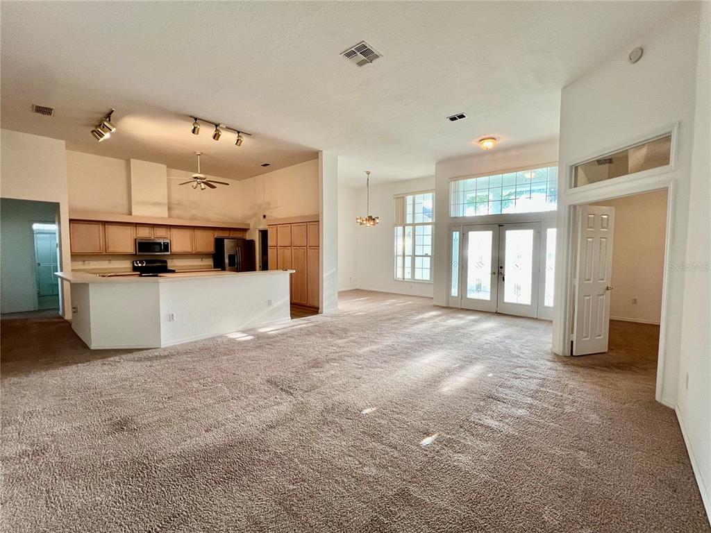 11159 Southwest 71st Terrace Road Ocala, FL 34476 - Photo 6 of 25 a view of a kitchen with a refrigerator and a stove top oven