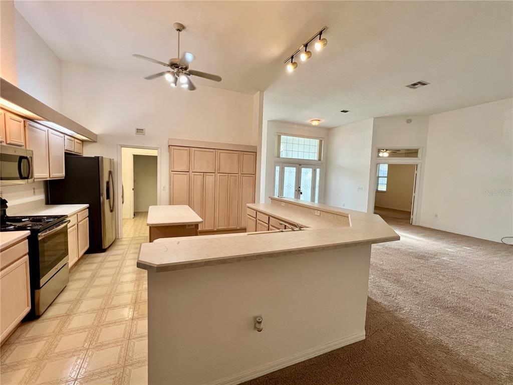 11159 Southwest 71st Terrace Road Ocala, FL 34476 - Photo 7 of 25 a kitchen with a stove a sink and a refrigerator