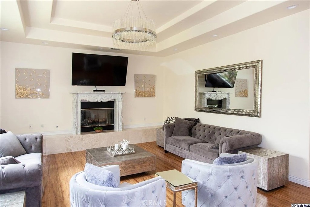 10062 Valley Cir Boulevard Chatsworth, CA 91311 - Photo 14 of 35 a living room with furniture a flat screen tv and a fireplace